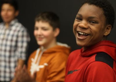 African American, white and hispanic middle school boys smiling