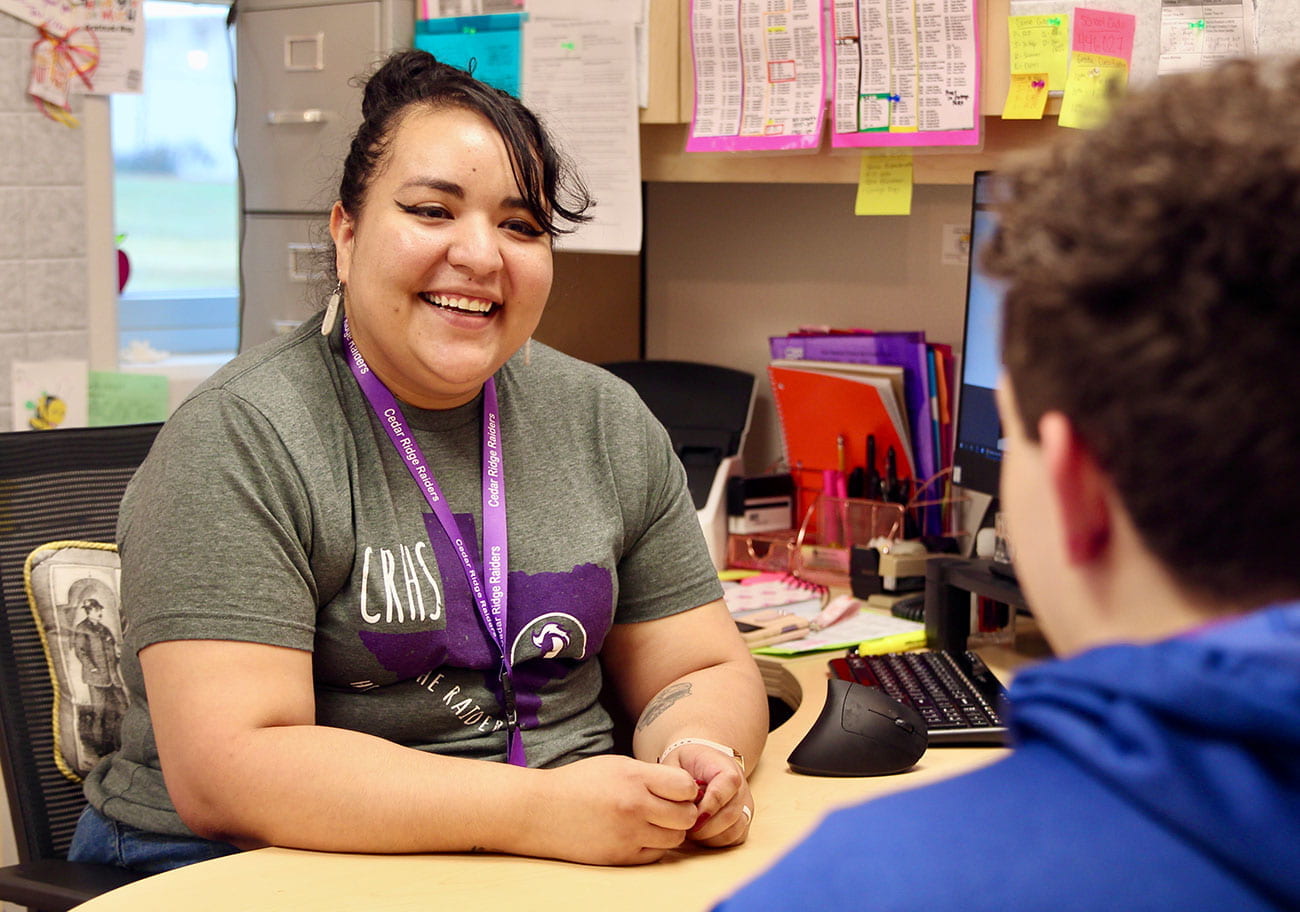 Counselor at Cedar Ridge High School talking with a student