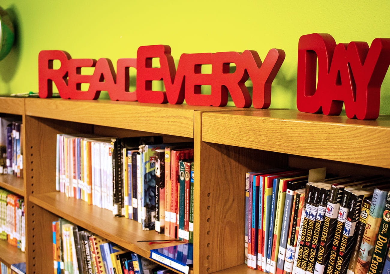 Photo of books on shelves in a school library